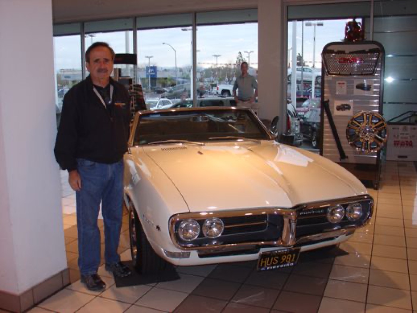 Member proudly presenting white Firebird convertible