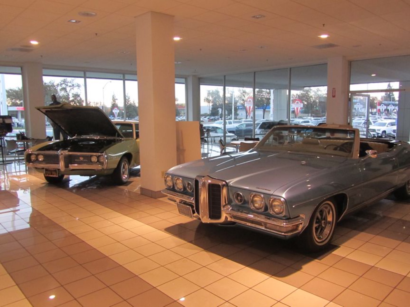 Classic Pontiacs lined up in showroom