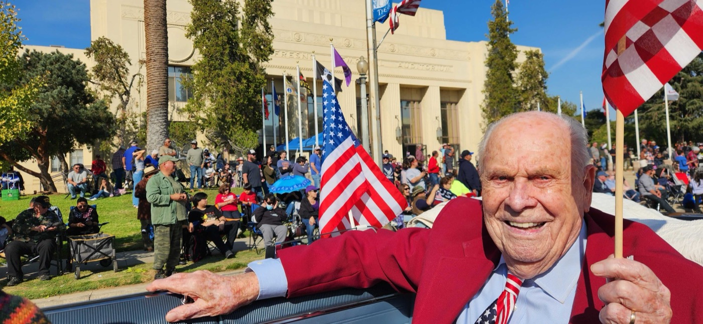 Smiling veteran waving the flag with pride